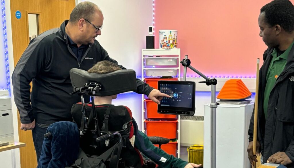 Unlocking Independence: How Tobii Dynavox Eye Gaze Technology Transforms Lives at the Peach Care Activity Centre in Milton Keynes 1 Tobii Dynavox technician setting up Eye Gaze Technology in Milton Keynes for a client at Peach Care Activity Centre
