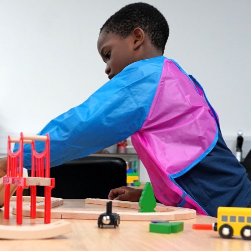 Kid playing with a train set